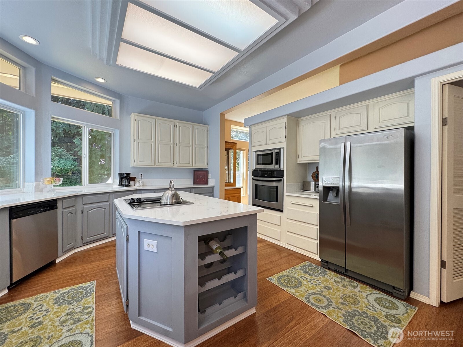 77 Rd Less Traveled Way Sequim, WA 98382 - Photo 12 of 40 a kitchen with kitchen island granite countertop a sink appliances and cabinets