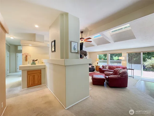 a bathroom with a granite countertop sink a mirror and a bathtub