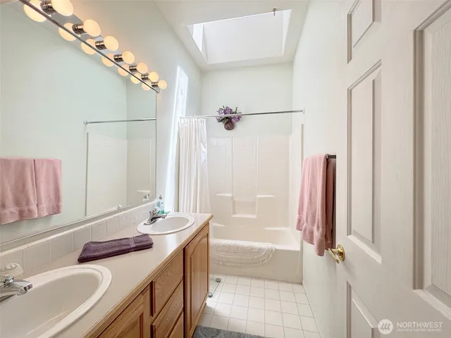 a bedroom with a bed a desk and chair next to a window