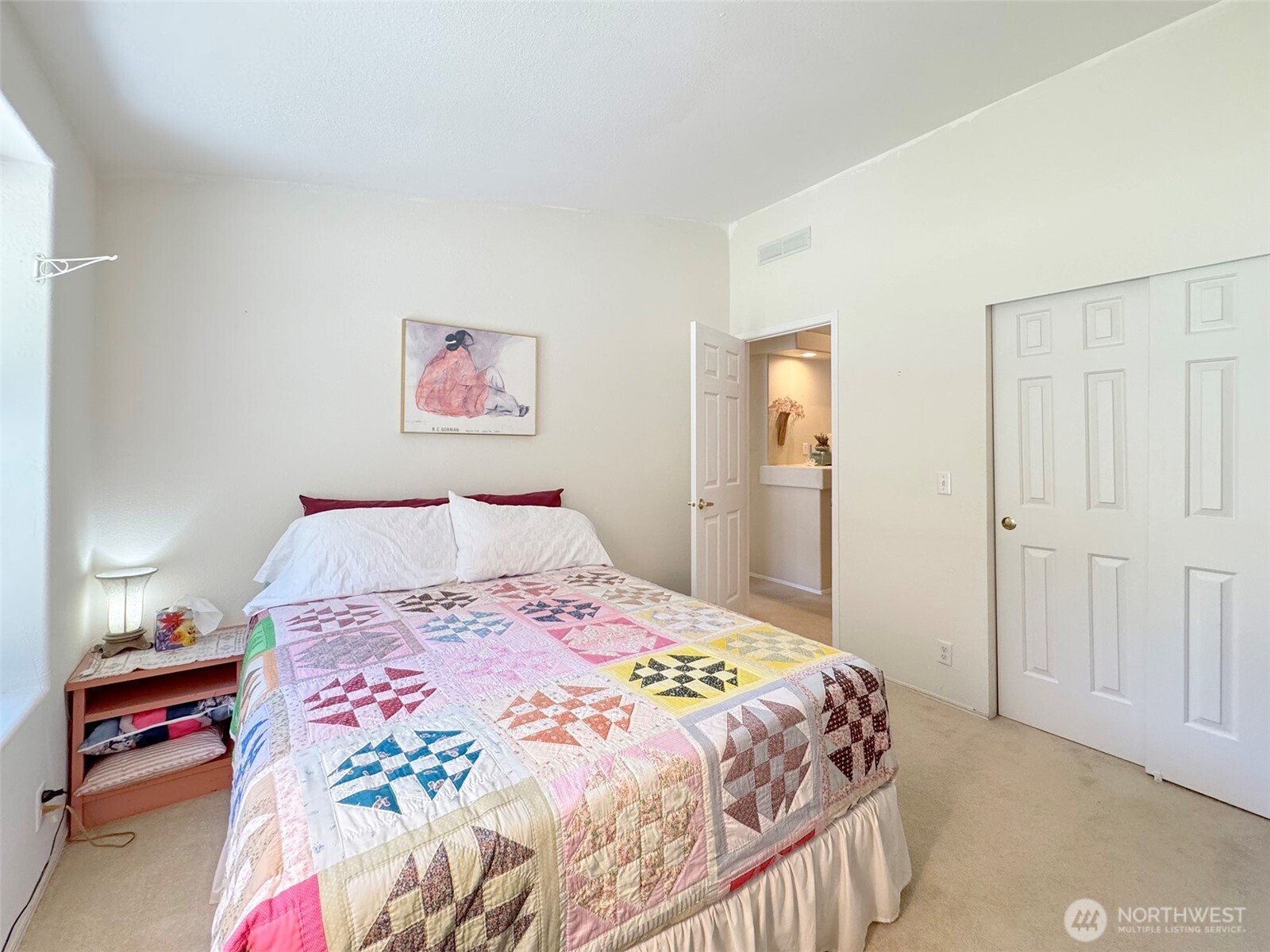 77 Rd Less Traveled Way Sequim, WA 98382 - Photo 20 of 40 a bedroom with a bed and a lamp on dresser