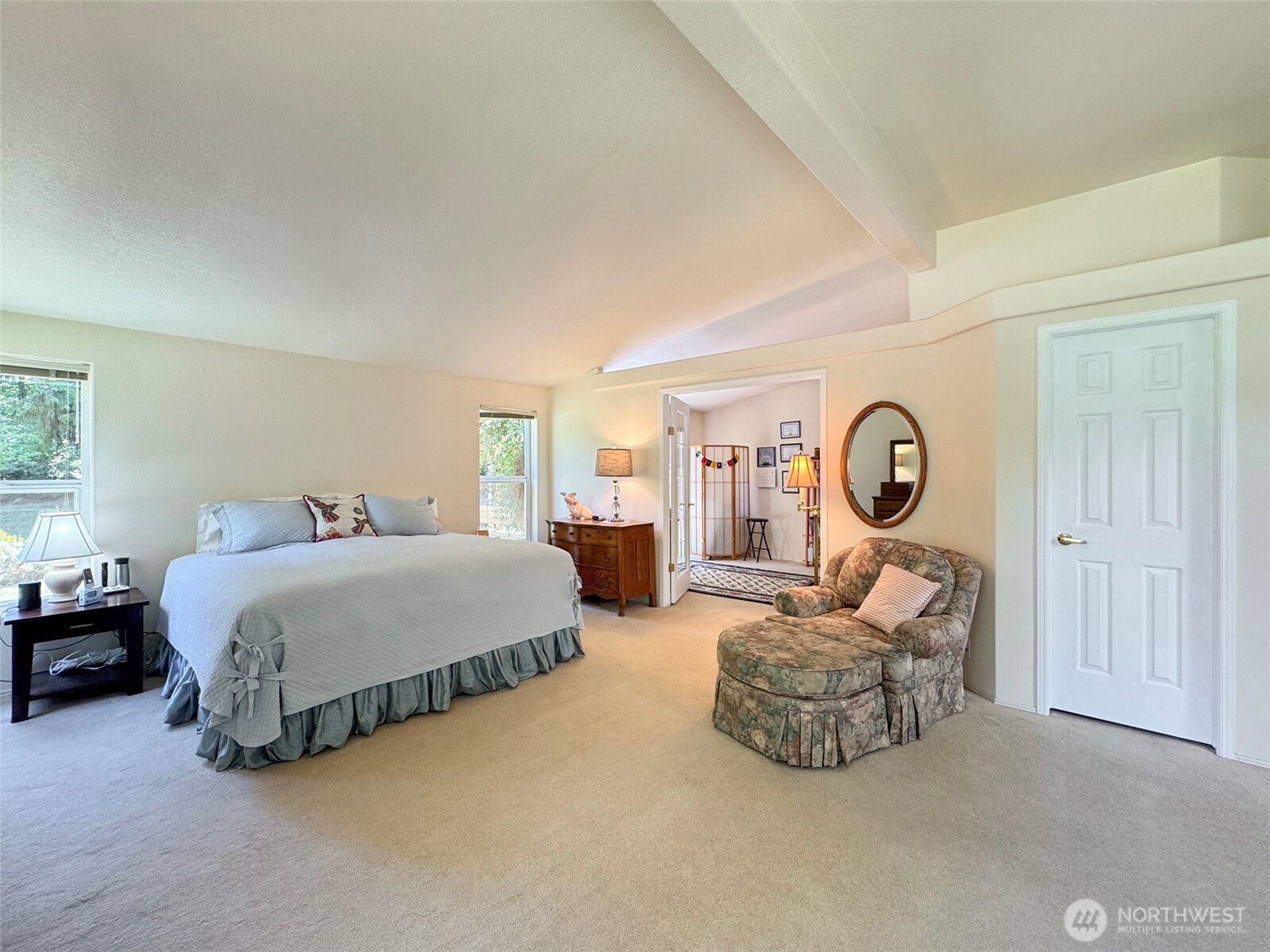 77 Rd Less Traveled Way Sequim, WA 98382 - Photo 25 of 40 a spacious bedroom with a bed and a large window