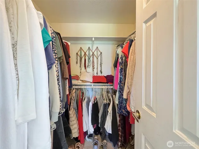 a view of a hallway with closet and a livingroom view