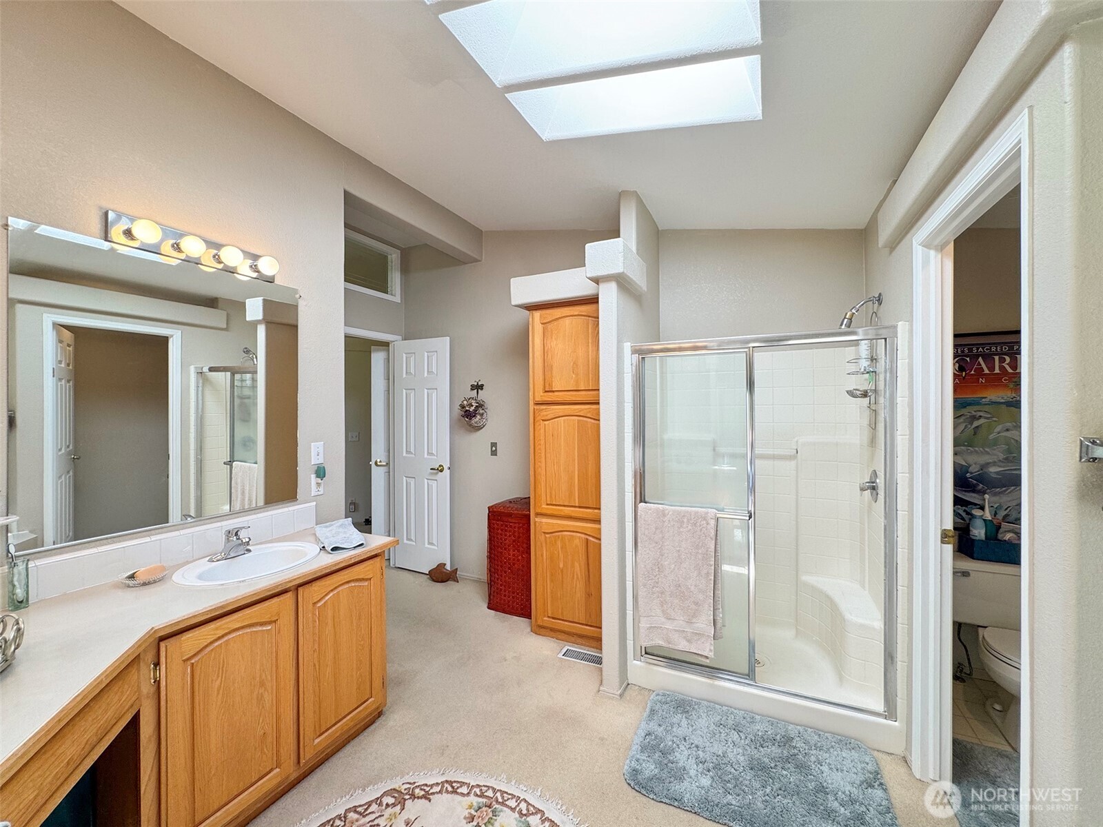 77 Rd Less Traveled Way Sequim, WA 98382 - Photo 30 of 40 a spacious bathroom with a granite countertop sink mirror and shower