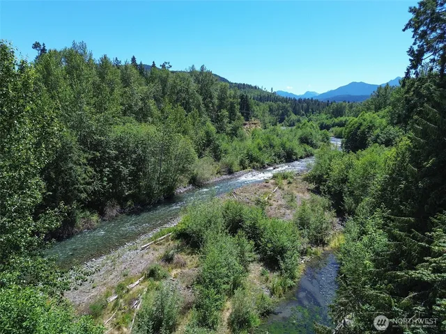 a view of a mountain range with trees in the background