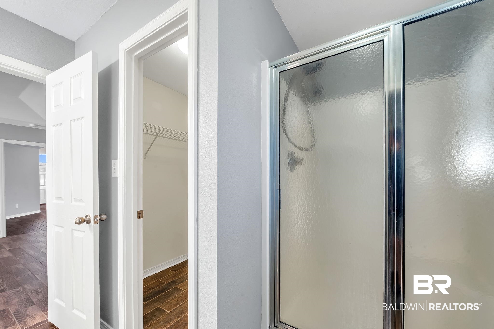 16444 Hamlet Lane Foley, AL 36535 - Photo 29 of 49 Full bath featuring baseboards, wood tiled floor, a walk in closet, and a shower stall