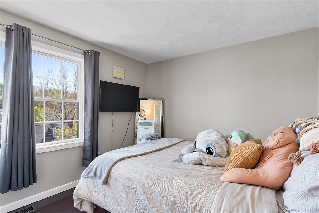10 Station Road Salem, MA 01970 - Photo 18 of 37 a bedroom with a bed tv and a window