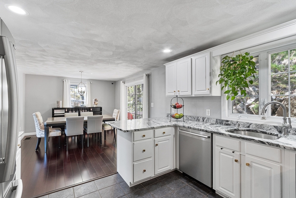 10 Station Road Salem, MA 01970 - Photo 2 of 37 a kitchen with a white cabinets and chairs