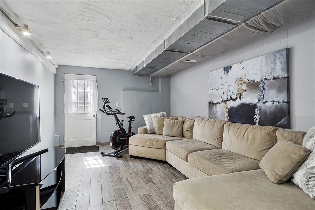 10 Station Road Salem, MA 01970 - Photo 25 of 37 a living room with furniture and a flat screen tv