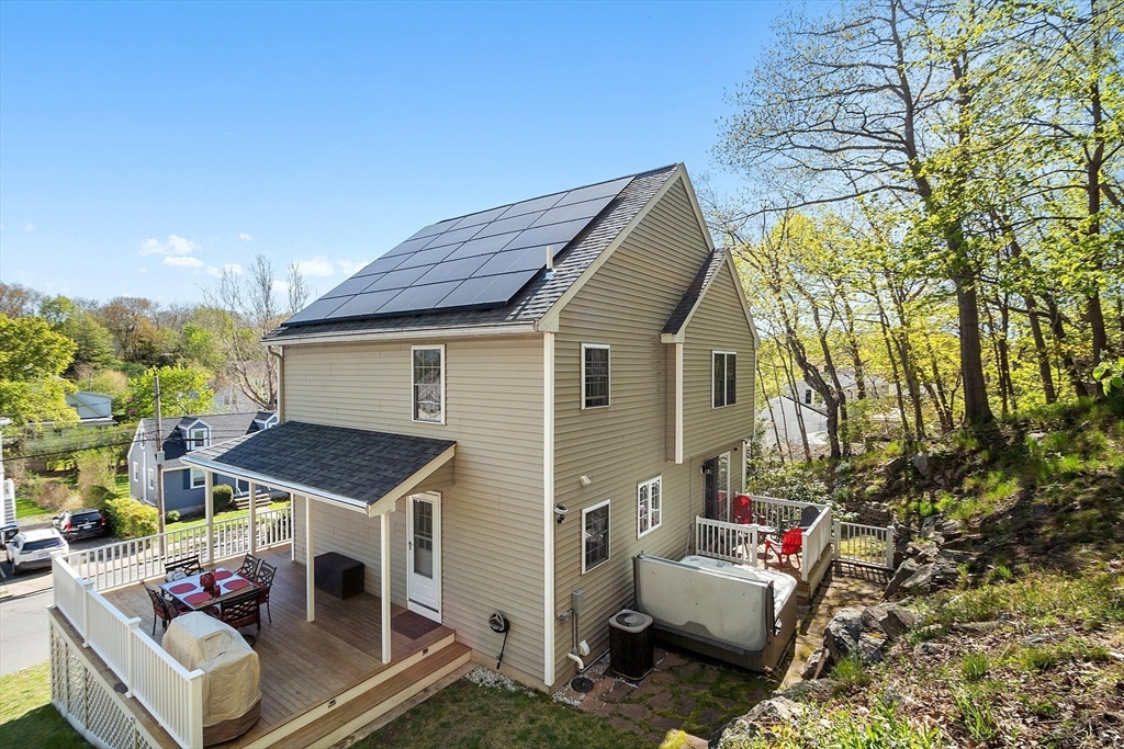 10 Station Road Salem, MA 01970 - Photo 33 of 37 a view of a patio with couches table and chairs under an umbrella