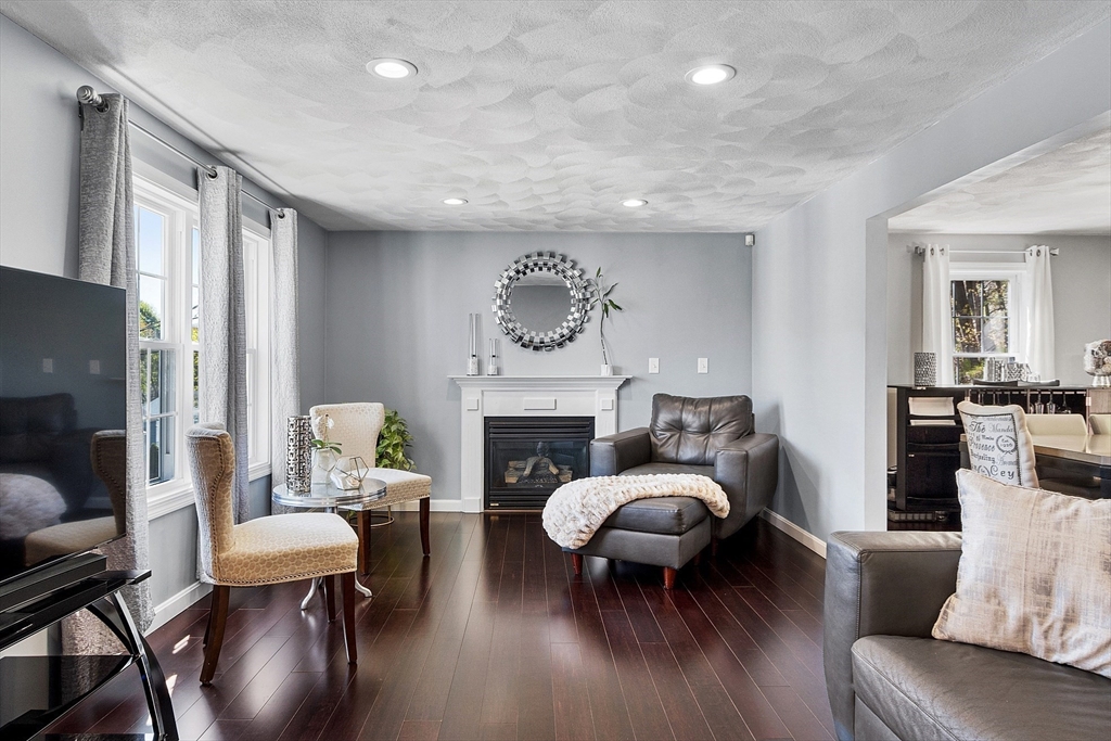 10 Station Road Salem, MA 01970 - Photo 8 of 37 a living room with furniture and a fireplace