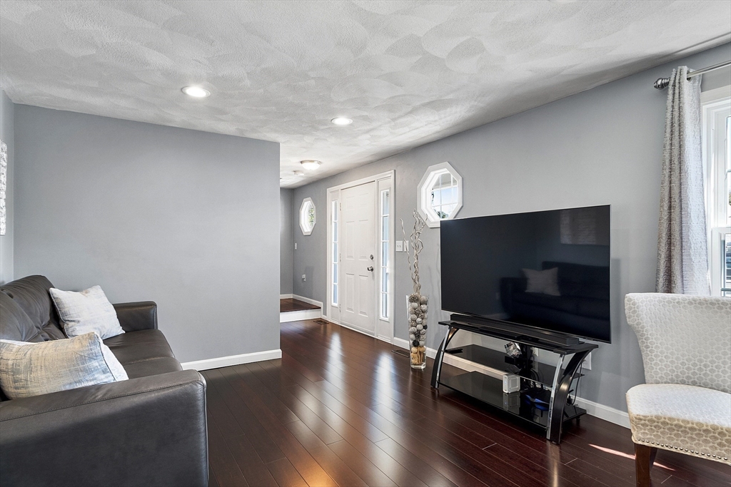 10 Station Road Salem, MA 01970 - Photo 9 of 37 a living room with furniture and a flat screen tv