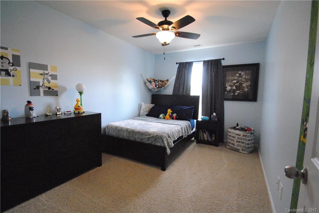 9203 Yellow Oak Road Charlotte, NC 28227 - Photo 13 of 17 a bedroom with a bed and a chandelier