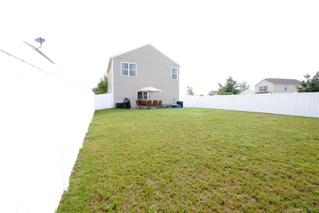 9203 Yellow Oak Road Charlotte, NC 28227 - Photo 16 of 17 a view of a house with a yard and garage