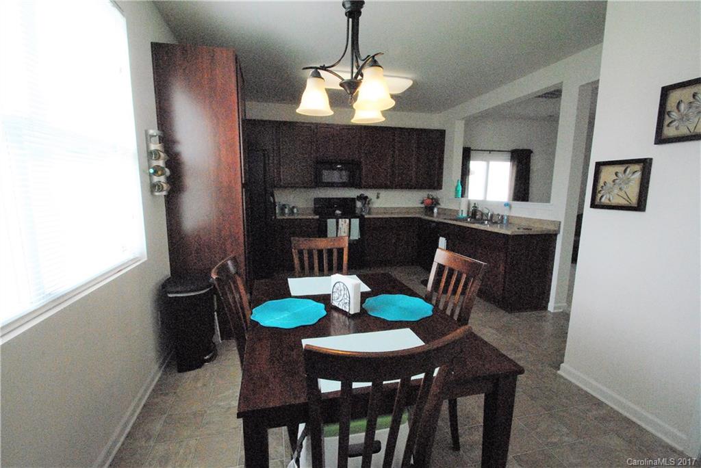 9203 Yellow Oak Road Charlotte, NC 28227 - Photo 5 of 17 a view of a dining room with furniture window and wooden floor