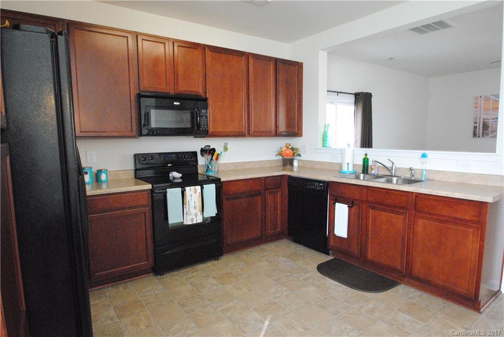 9203 Yellow Oak Road Charlotte, NC 28227 - Photo 7 of 17 a kitchen with stainless steel appliances granite countertop a refrigerator stove top oven and sink