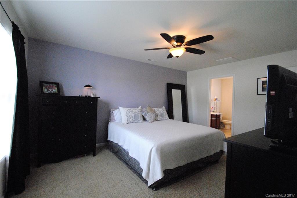 9203 Yellow Oak Road Charlotte, NC 28227 - Photo 9 of 17 a bedroom with a bed and a chandelier