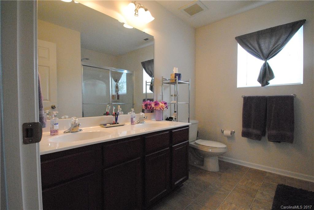 9203 Yellow Oak Road Charlotte, NC 28227 - Photo 10 of 17 a bathroom with a toilet sink double vanity and mirror