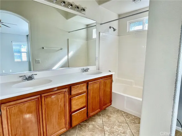 a bathroom with a tub sink and mirror