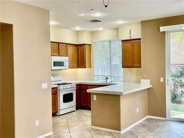 a kitchen with stainless steel appliances granite countertop a sink and a stove top oven