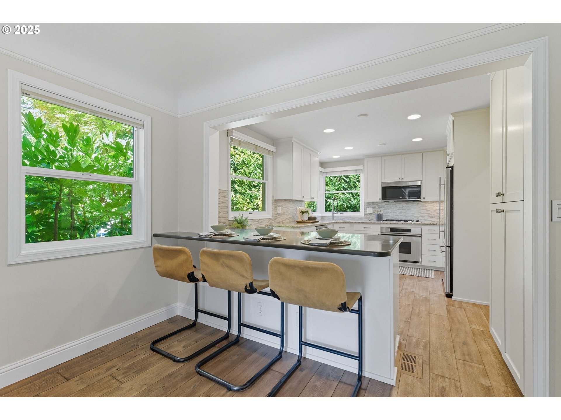 3190 Southwest Ridgewood Avenue Portland, OR 97225 - Photo 12 of 41 a kitchen with a dining table chairs and window