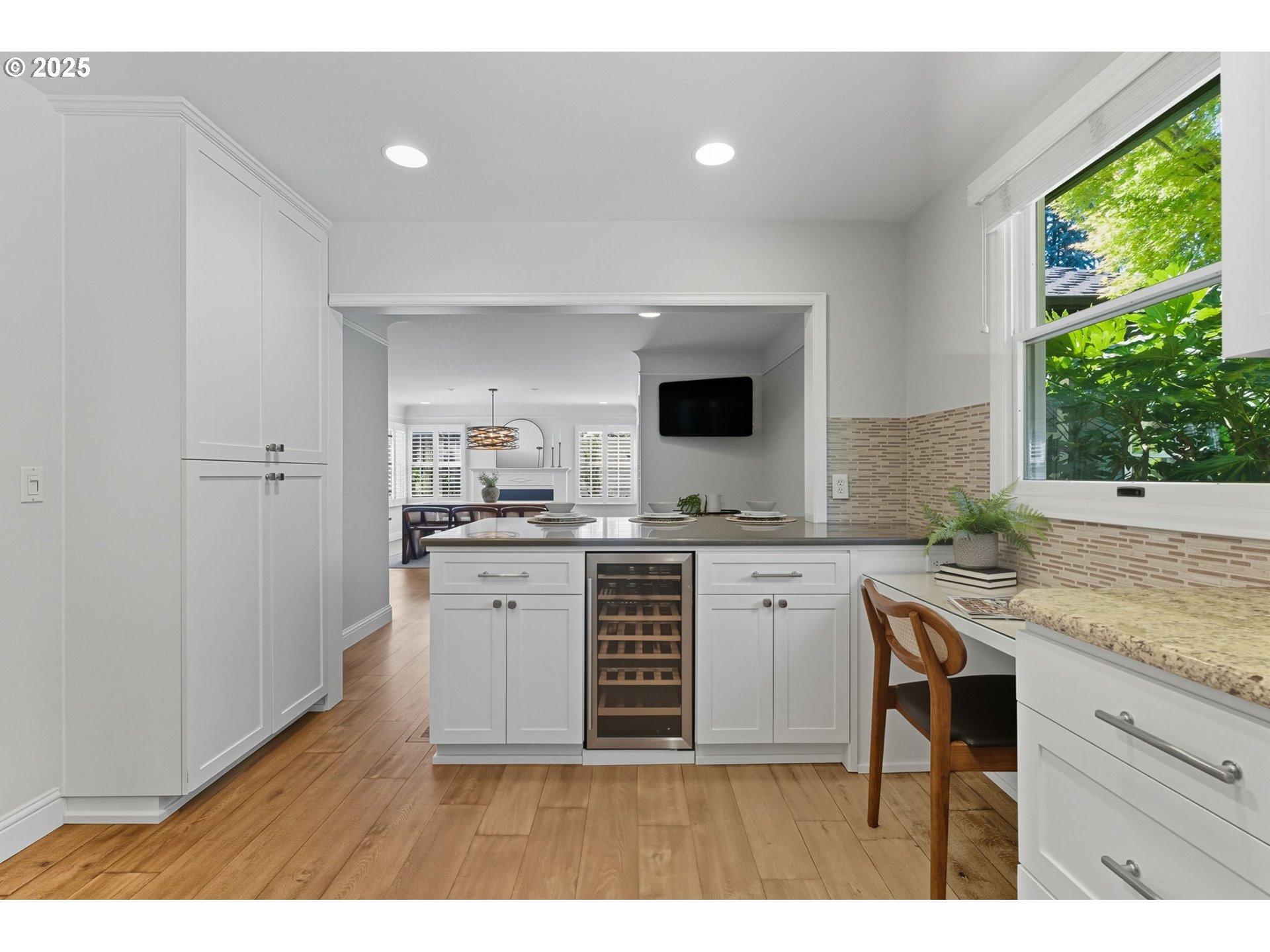 3190 Southwest Ridgewood Avenue Portland, OR 97225 - Photo 18 of 41 a kitchen with kitchen island granite countertop a sink and cabinets