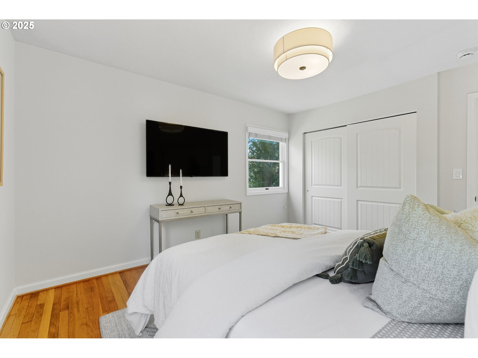 3190 Southwest Ridgewood Avenue Portland, OR 97225 - Photo 20 of 41 a bedroom with a bed and a flat screen tv
