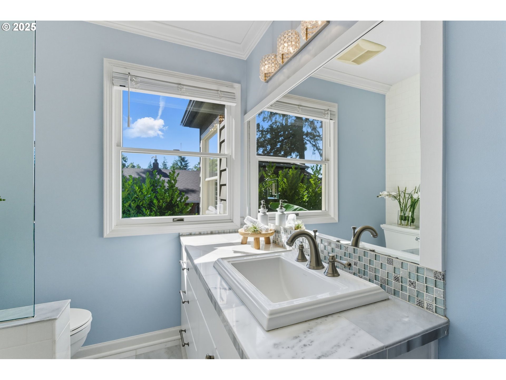 3190 Southwest Ridgewood Avenue Portland, OR 97225 - Photo 21 of 41 a bathroom with a sink mirror and window