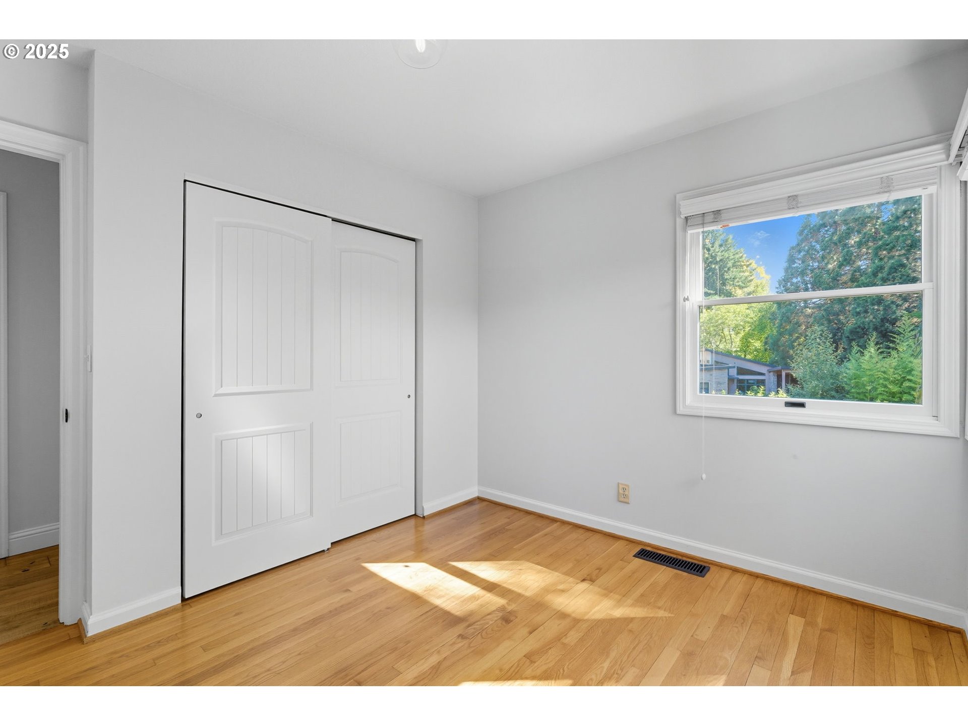 3190 Southwest Ridgewood Avenue Portland, OR 97225 - Photo 24 of 41 a view of empty room with wooden floor and fan