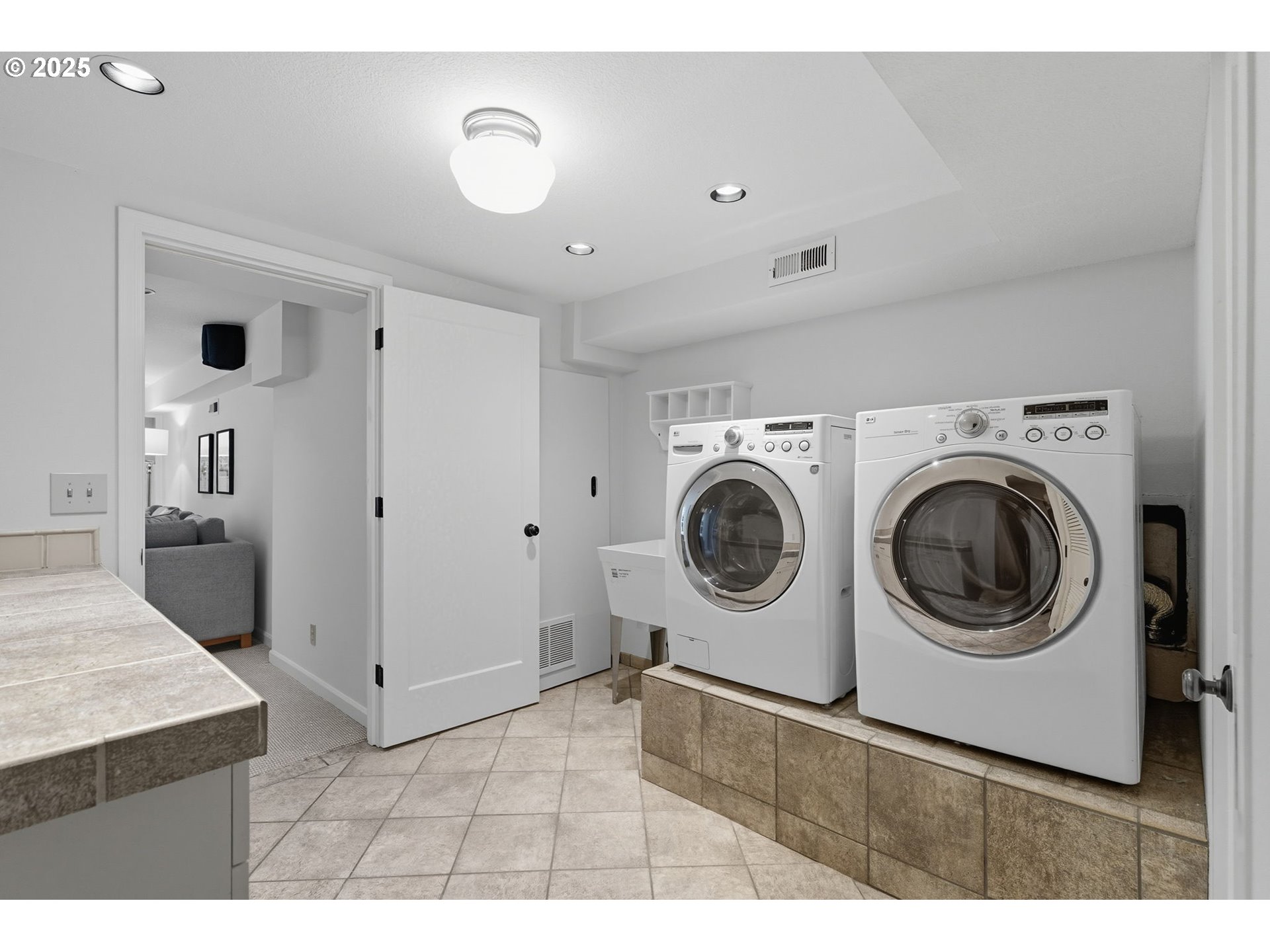 3190 Southwest Ridgewood Avenue Portland, OR 97225 - Photo 28 of 41 a view of a kitchen with washing machine and a sink