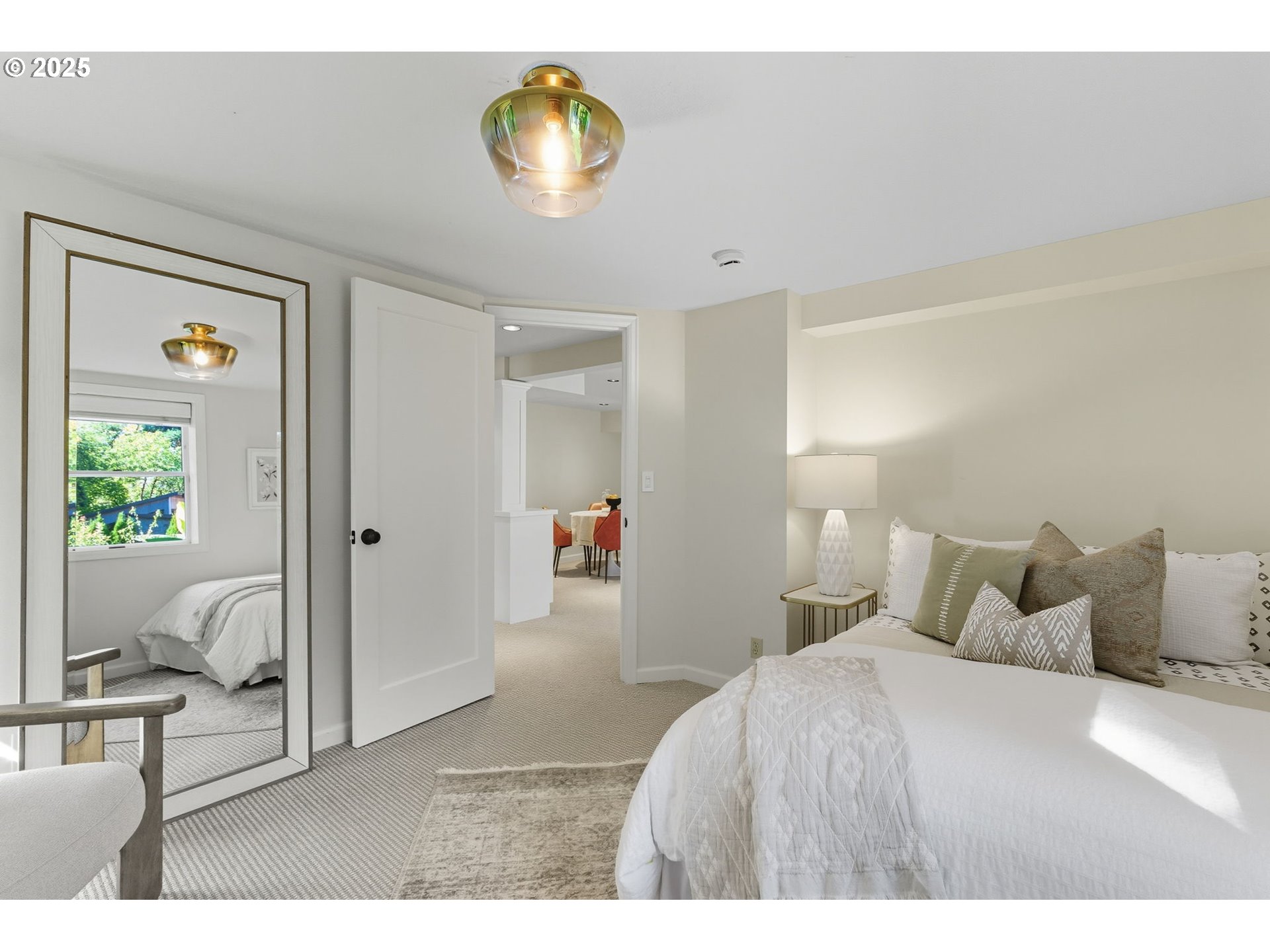 3190 Southwest Ridgewood Avenue Portland, OR 97225 - Photo 31 of 41 a bedroom with a bed and a chandelier