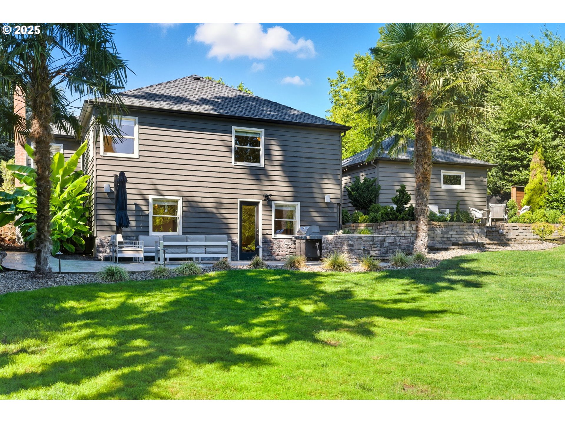 3190 Southwest Ridgewood Avenue Portland, OR 97225 - Photo 37 of 41 a view of a house with a yard and sitting area
