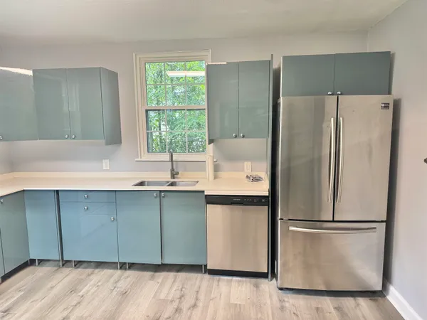a kitchen with stainless steel appliances a refrigerator and a sink