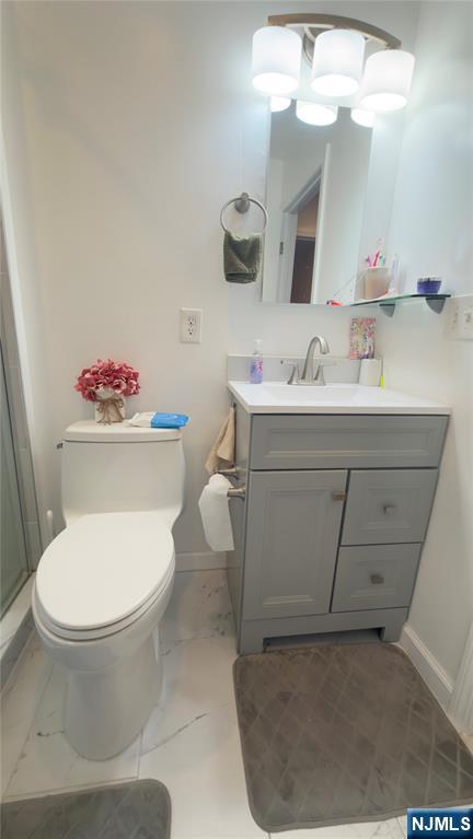 246 Harding Avenue Clifton, NJ 07011 - Photo 19 of 28 a bathroom with a sink toilet and mirror