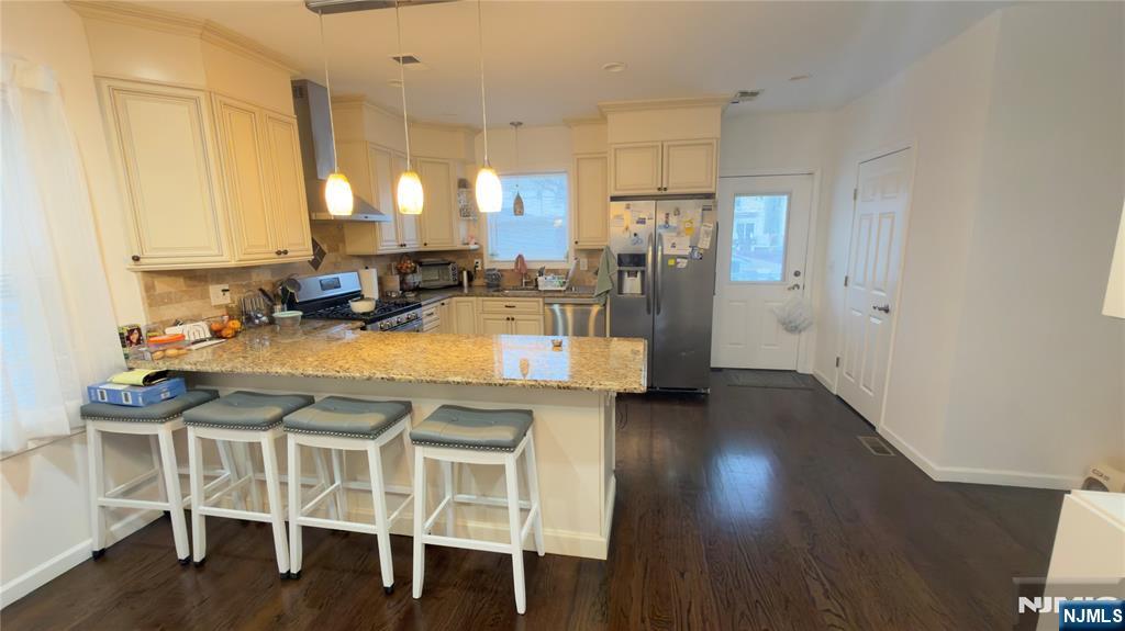 246 Harding Avenue Clifton, NJ 07011 - Photo 4 of 28 a kitchen with a table chairs refrigerator and cabinets