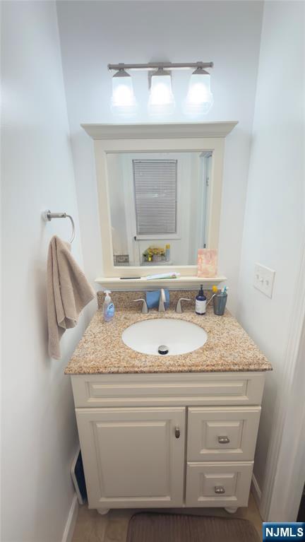 246 Harding Avenue Clifton, NJ 07011 - Photo 8 of 28 a bathroom with a granite countertop sink and a mirror