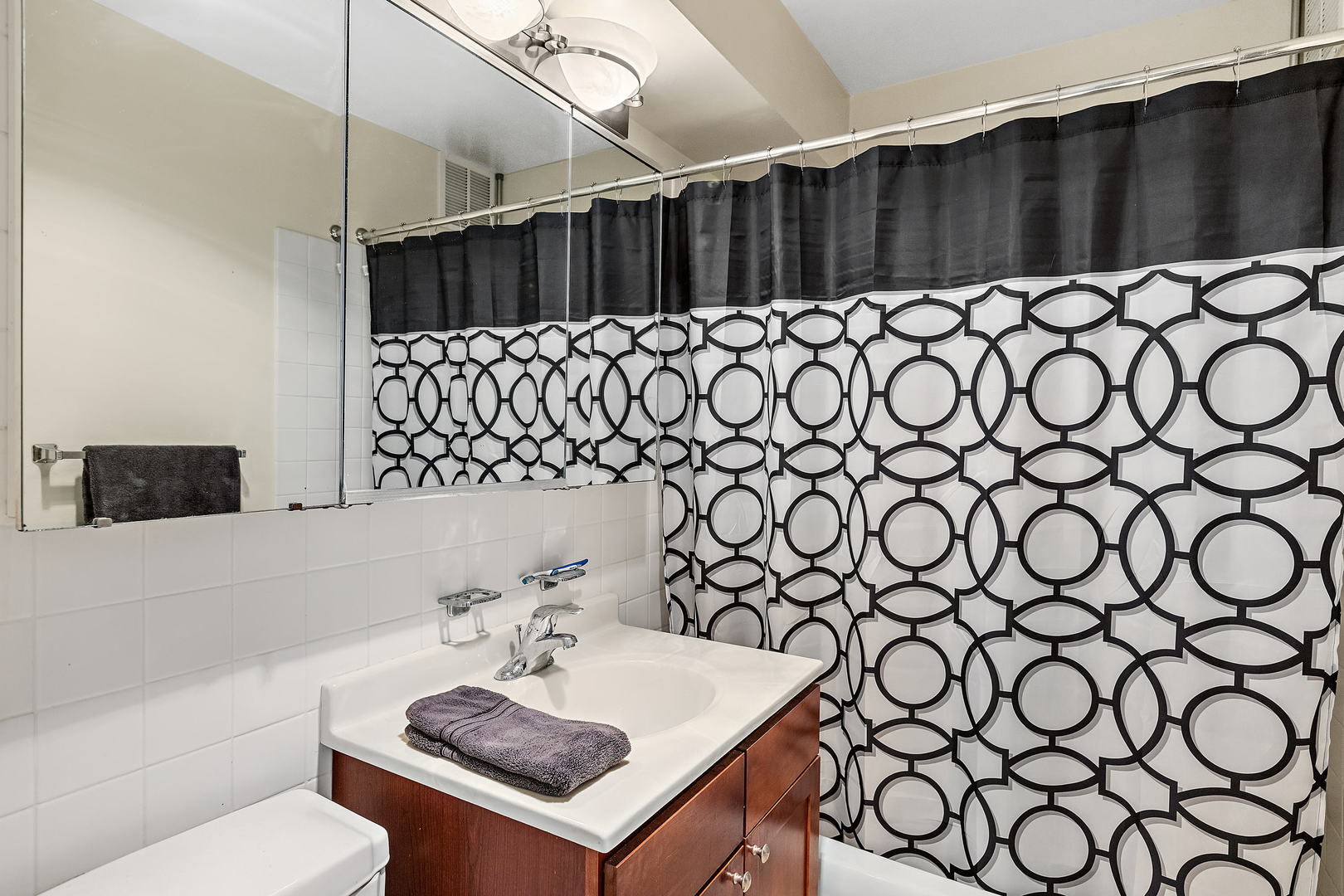 655 West Irving Park Road, Unit 4509 Chicago, IL 60613 - Photo 11 of 22 a bathroom with a sink and a mirror