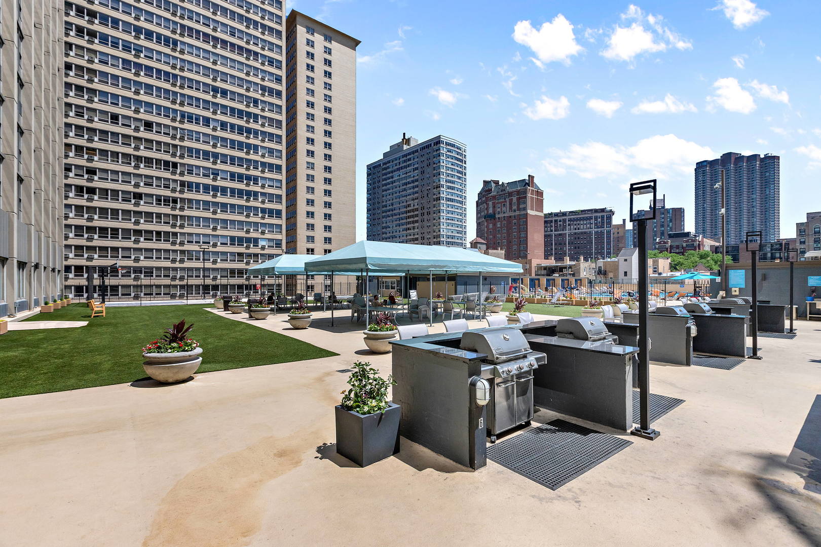 655 West Irving Park Road, Unit 4509 Chicago, IL 60613 - Photo 17 of 22 a view of a patio with couches chairs and a stove