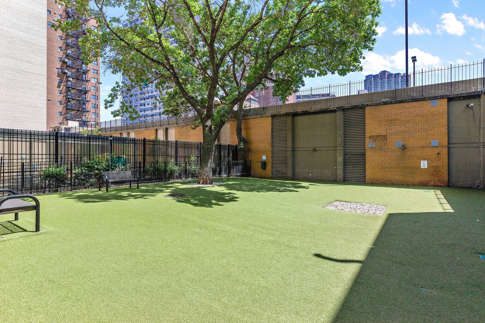 655 West Irving Park Road, Unit 4509 Chicago, IL 60613 - Photo 21 of 22 a view of a backyard with table and chairs and potted plants