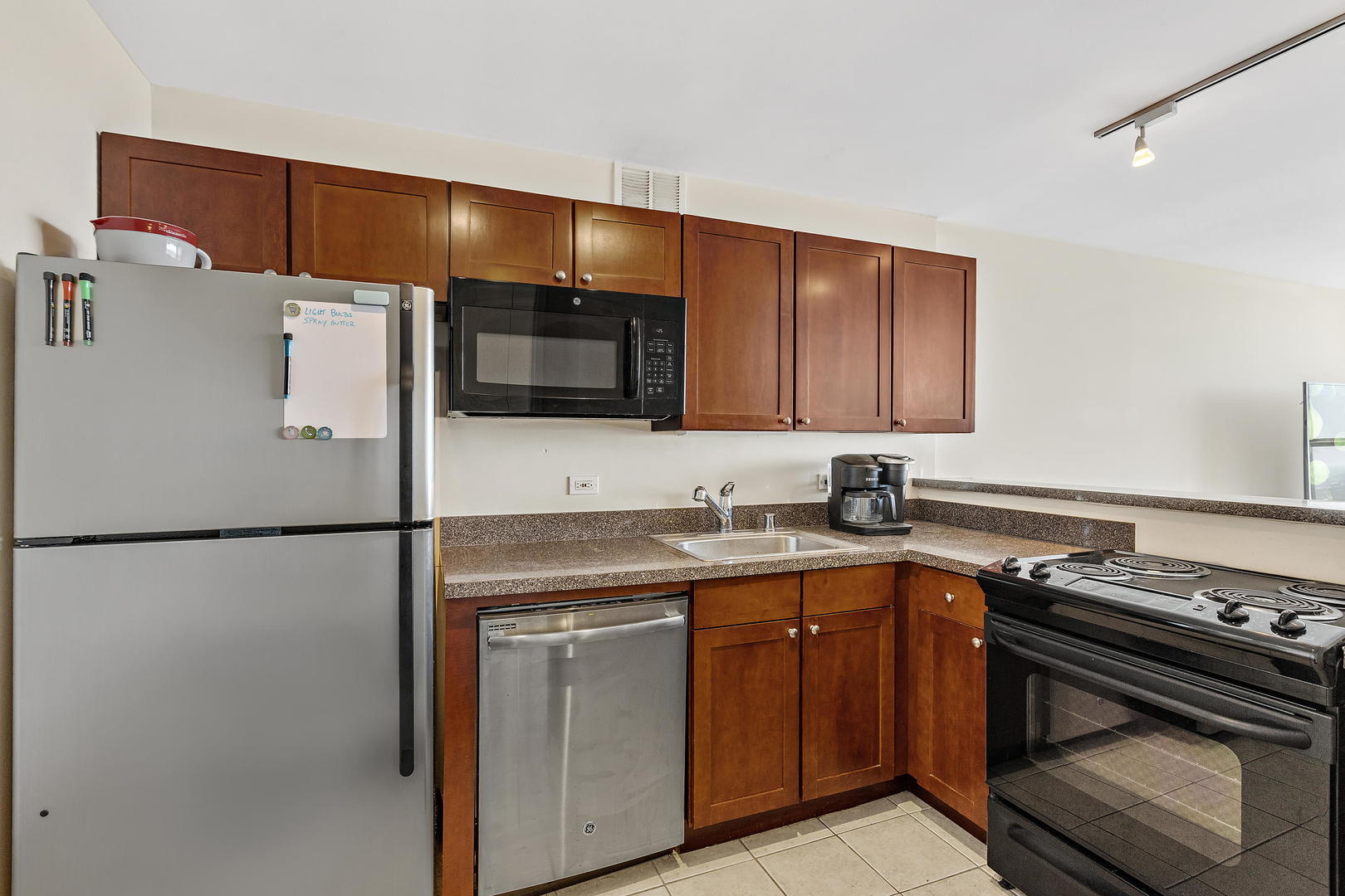 655 West Irving Park Road, Unit 4509 Chicago, IL 60613 - Photo 3 of 22 a kitchen with a refrigerator and a sink