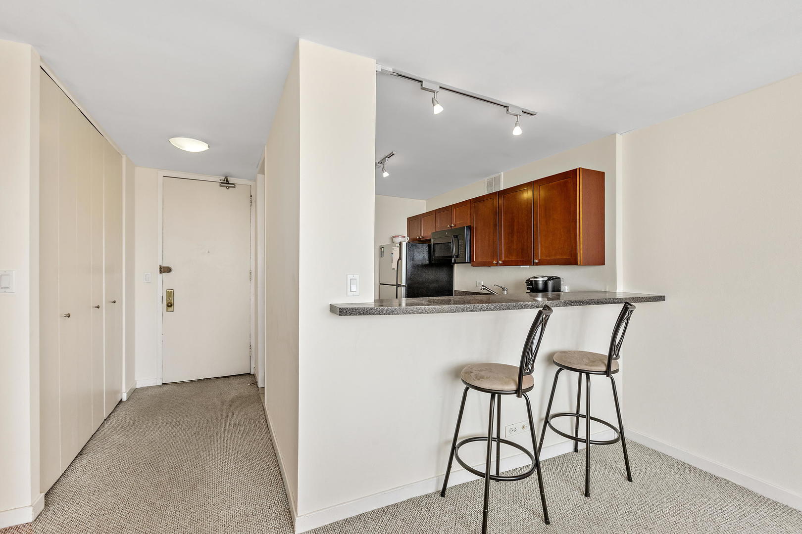 655 West Irving Park Road, Unit 4509 Chicago, IL 60613 - Photo 6 of 22 a view of a livingroom with furniture and flat screen tv