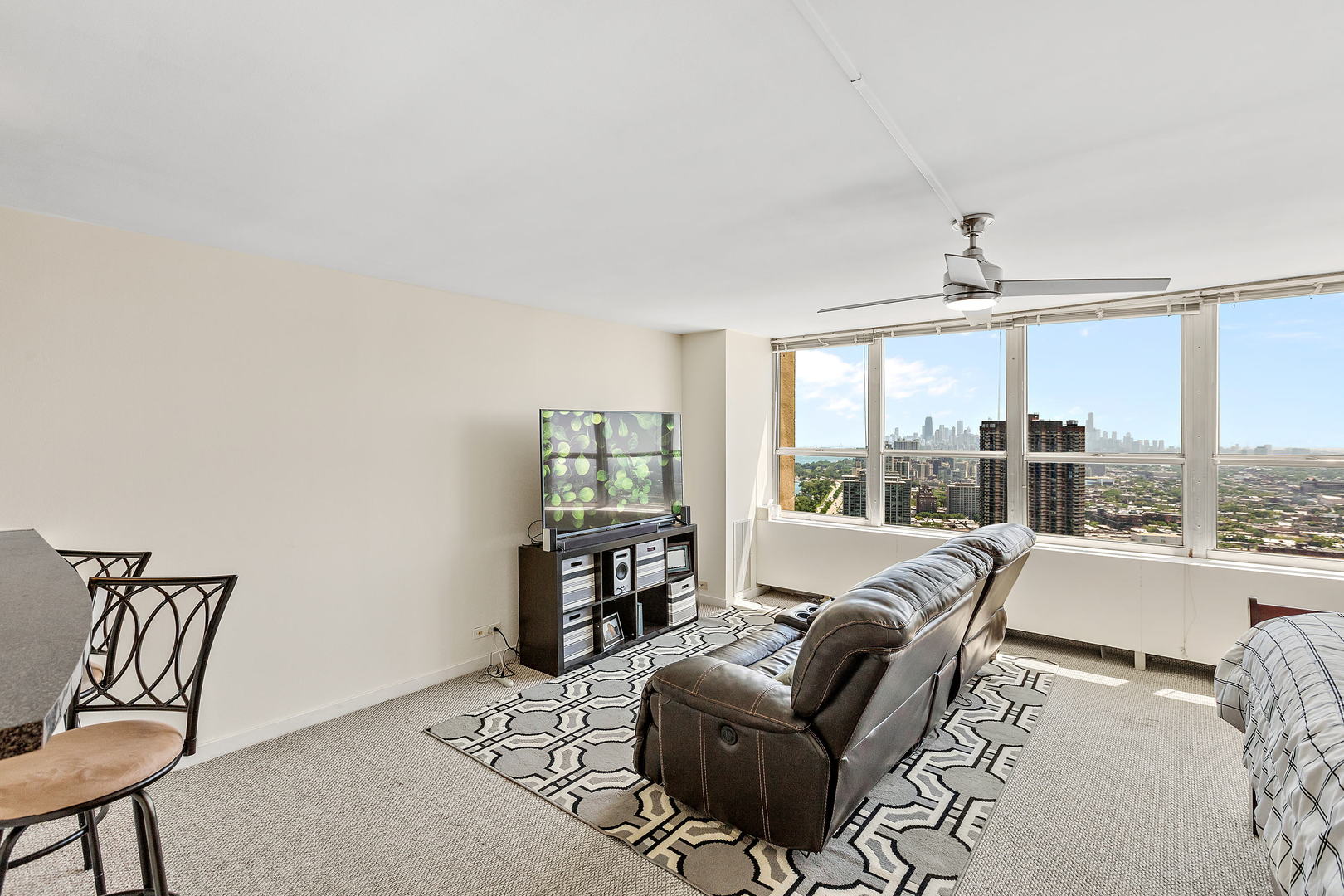 655 West Irving Park Road, Unit 4509 Chicago, IL 60613 - Photo 8 of 22 a living room with furniture and a large window