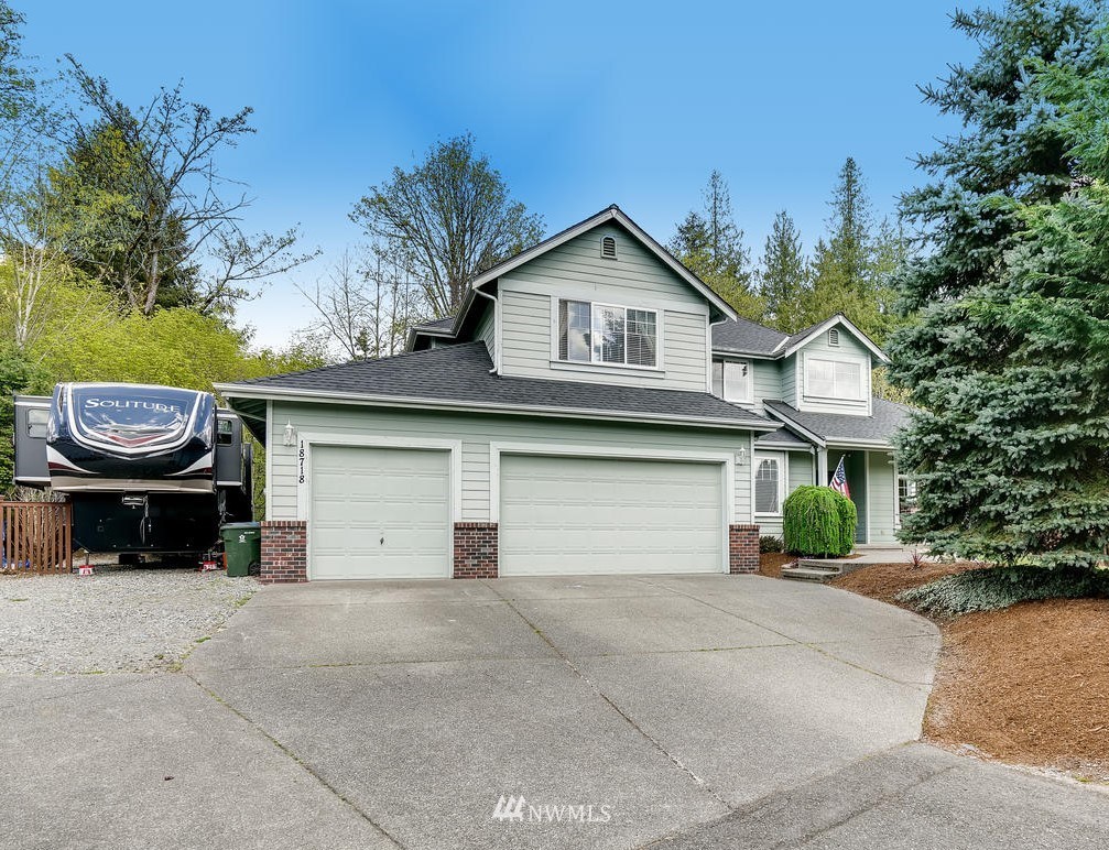 a front view of a house with a yard and garage