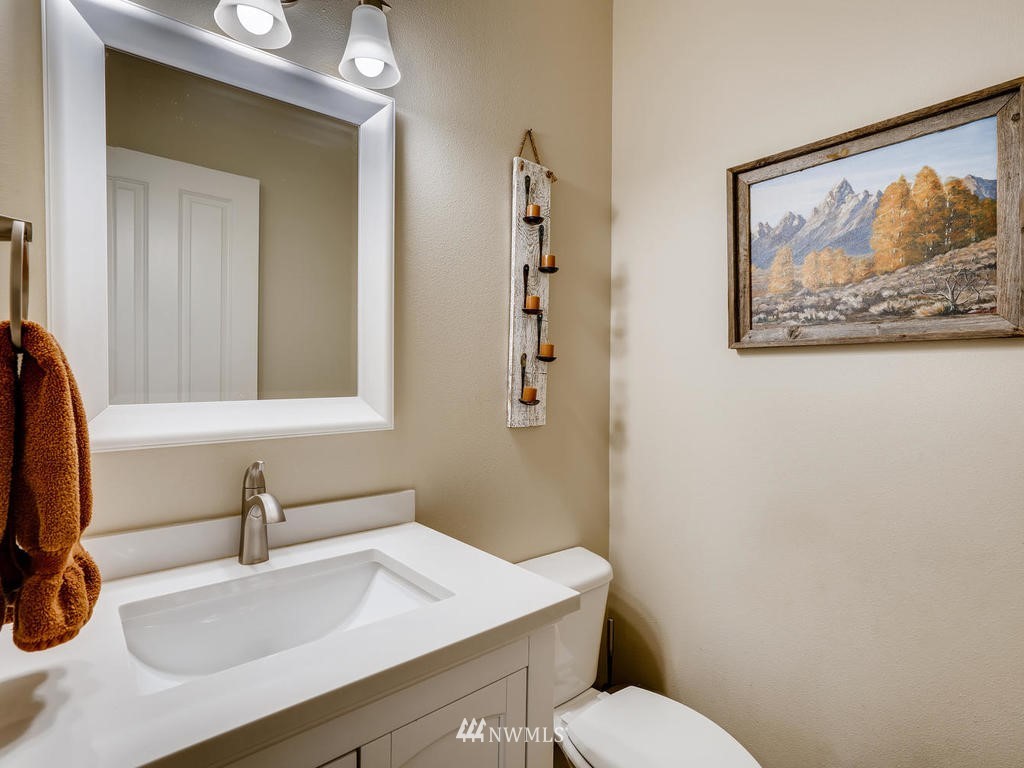 18718 Southeast 144th Street Renton, WA 98059 - Photo 11 of 25 a bathroom with a sink mirror and toilet