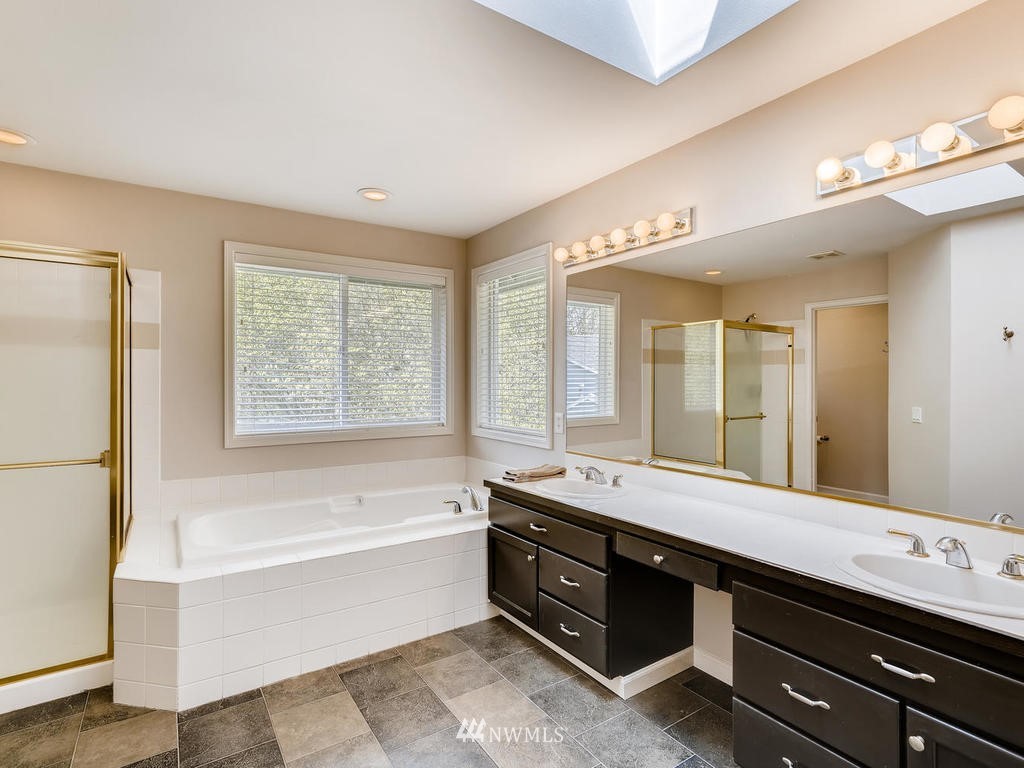 18718 Southeast 144th Street Renton, WA 98059 - Photo 14 of 25 a spacious bathroom with a large tub sink and mirror