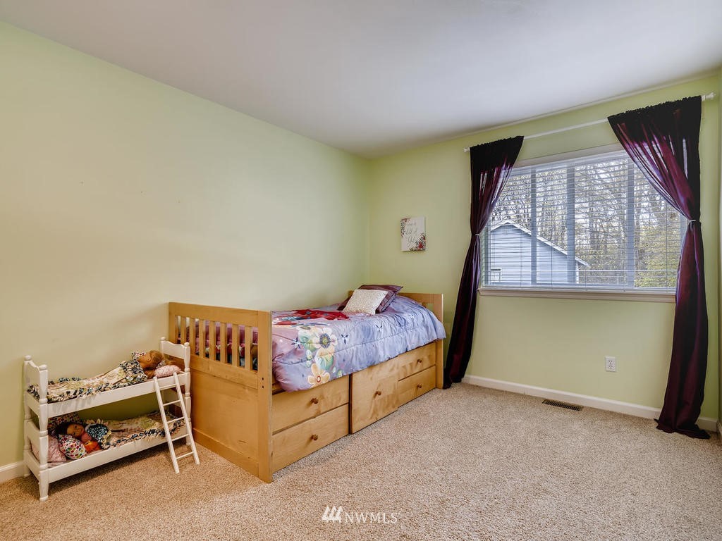 18718 Southeast 144th Street Renton, WA 98059 - Photo 18 of 25 a bedroom with a bed and a window