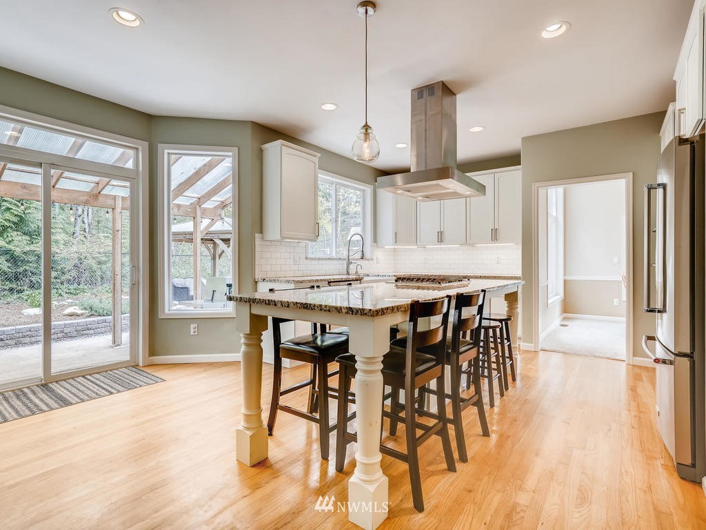 18718 Southeast 144th Street Renton, WA 98059 - Photo 5 of 25 a view of a a dining room with furniture window and wooden floor
