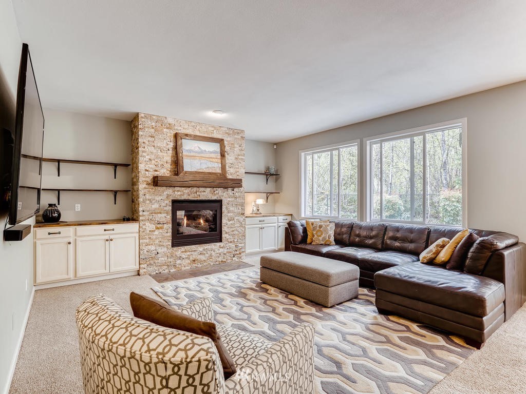 18718 Southeast 144th Street Renton, WA 98059 - Photo 6 of 25 a living room with furniture and a fireplace