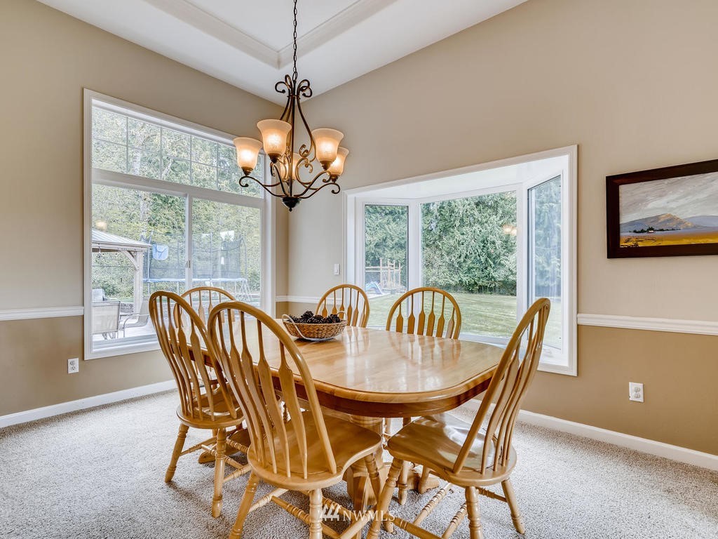 18718 Southeast 144th Street Renton, WA 98059 - Photo 9 of 25 a dining room with furniture a chandelier and window