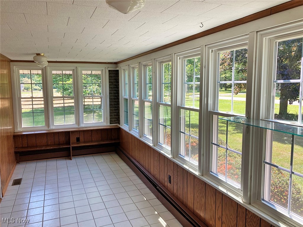 8309 Drake State Line Road Masury, OH 44438 - Photo 29 of 34 Unfurnished sunroom featuring baseboard heating and a healthy amount of sunlight