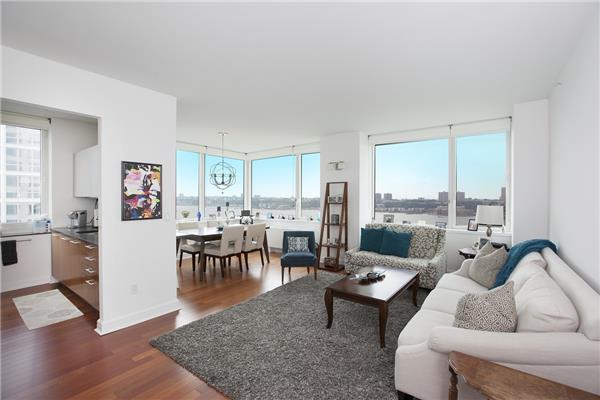 a living room with furniture large window and a table